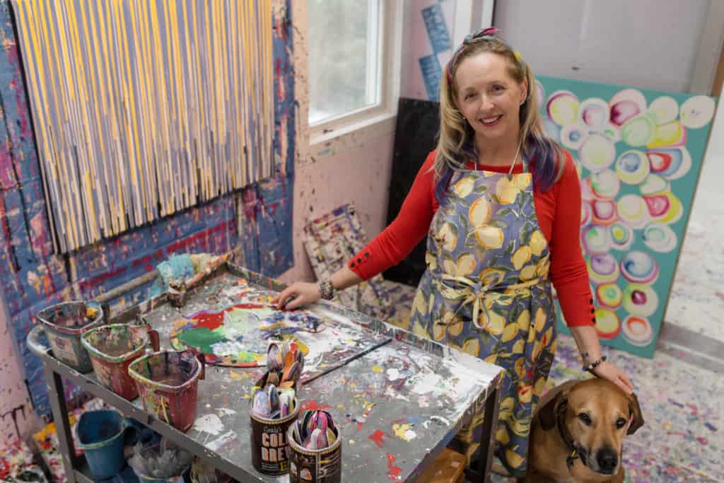Jilma and her Rhodesian Ridgeback dog in her art studio